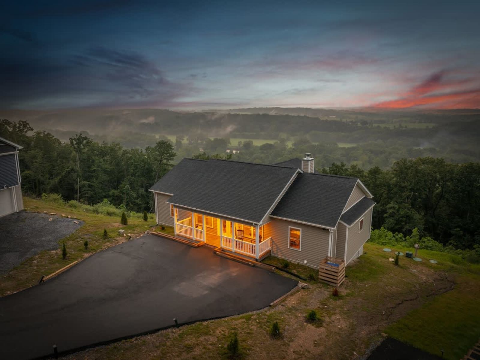 Aerial view at twilight of the house perched above the valley