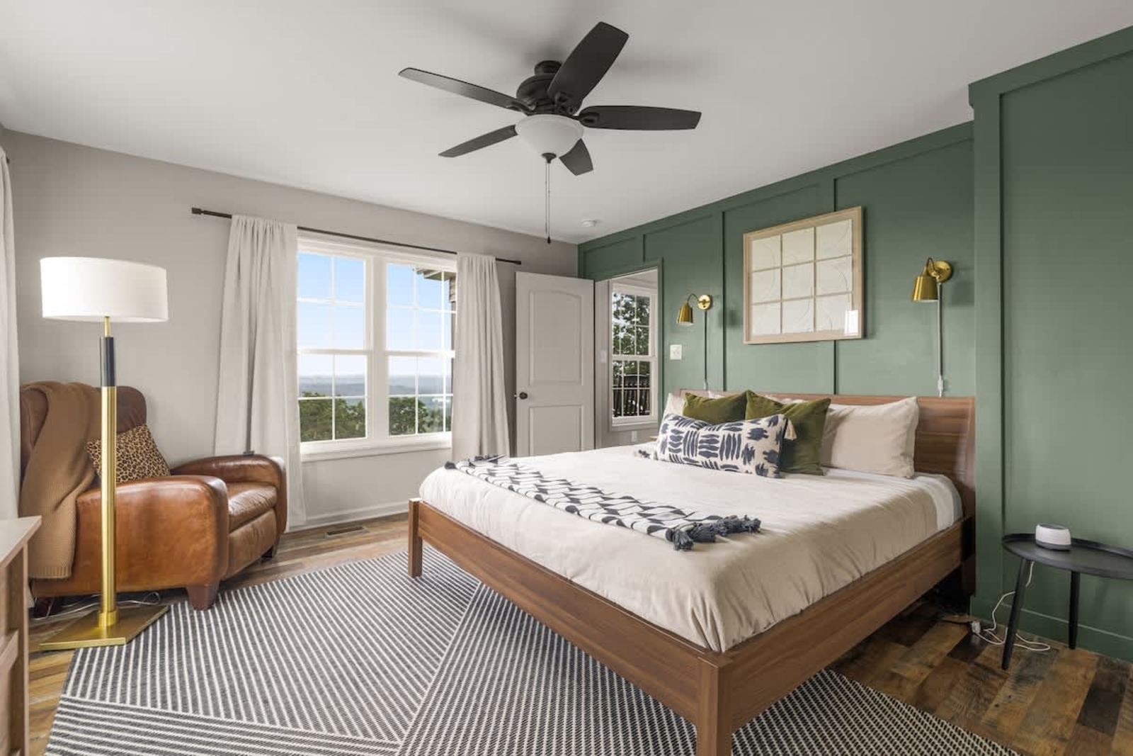 Primary bedroom with a king bed, ceiling fan, and a valley view